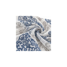 Close-up of navy and taupe damask print on white sheer curtain fabric