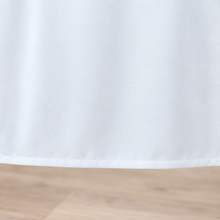 White tablecloth, fabric and hem closeup