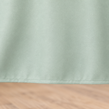 Green tablecloth, fabric and hem closeup